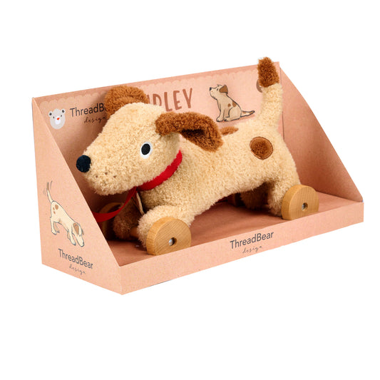 Plush dog toy with wheels in a 'ThreadBear' branded box on a white background