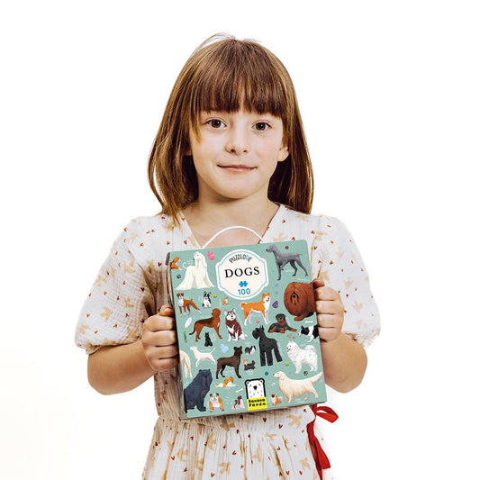 Child holding a book with dog illustrations on a white background