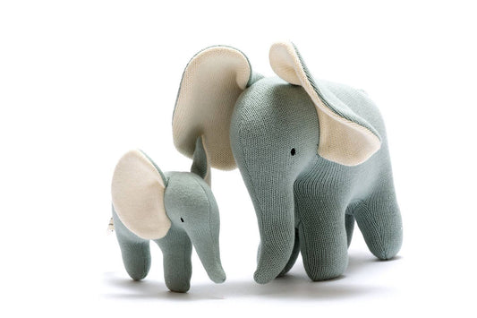 A large plush toy with a smaller toy in the shape of an elephant, with a teal body and beige details on its ears and trunk, made from organic cotton fabric.