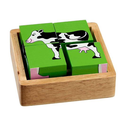 Wooden puzzle with cow design on green blocks in a wooden box