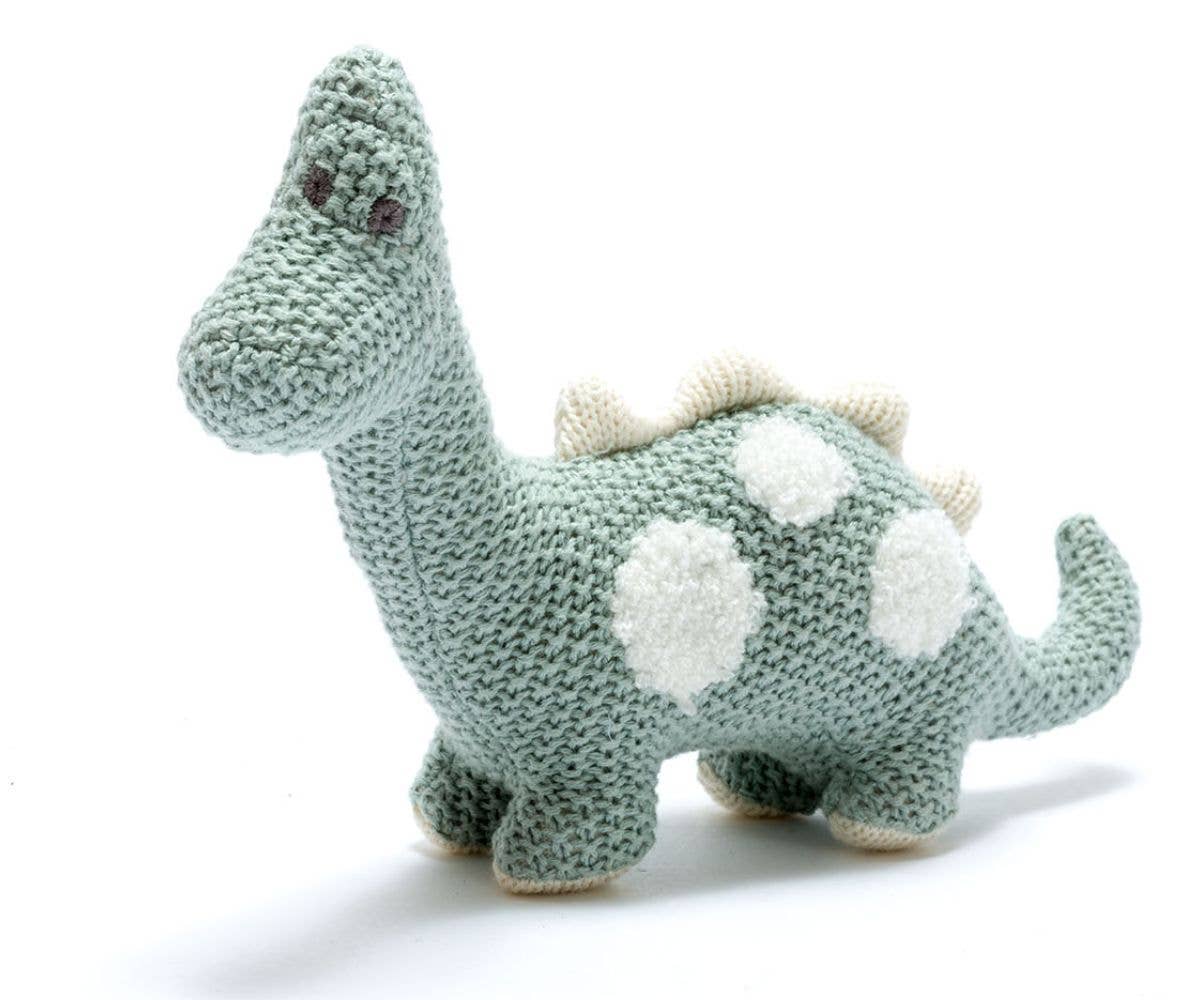 Soft knitted teal dinosaur toy with white spots and small beige spikes, handmade in an eco-friendly design