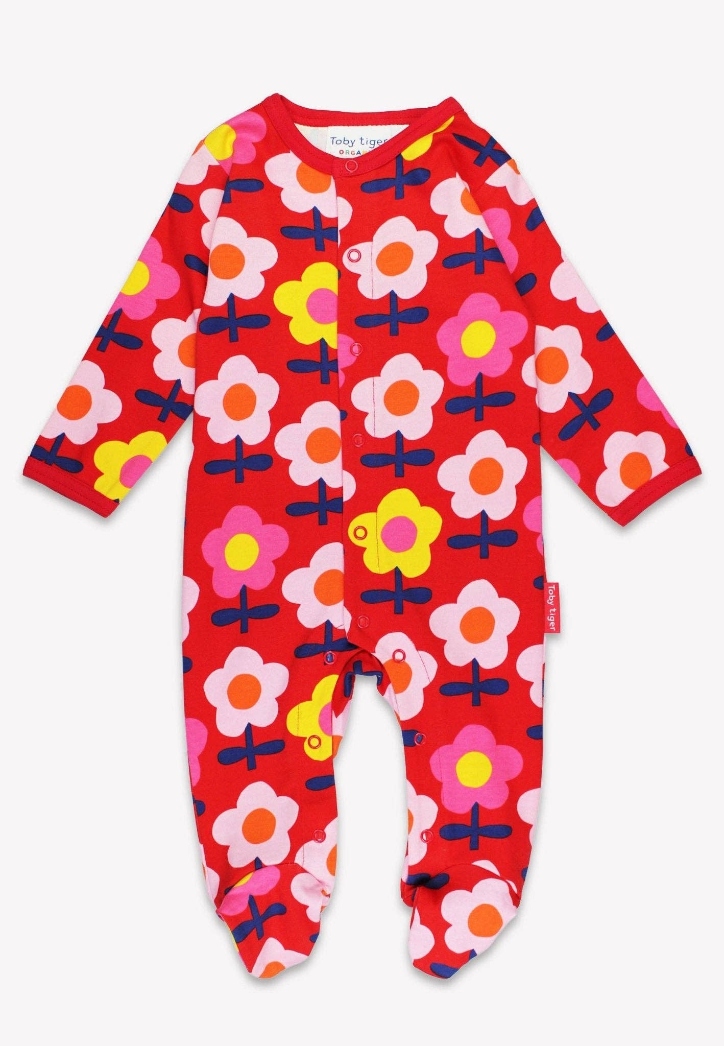 Red baby onesie with colorful floral pattern on a white background