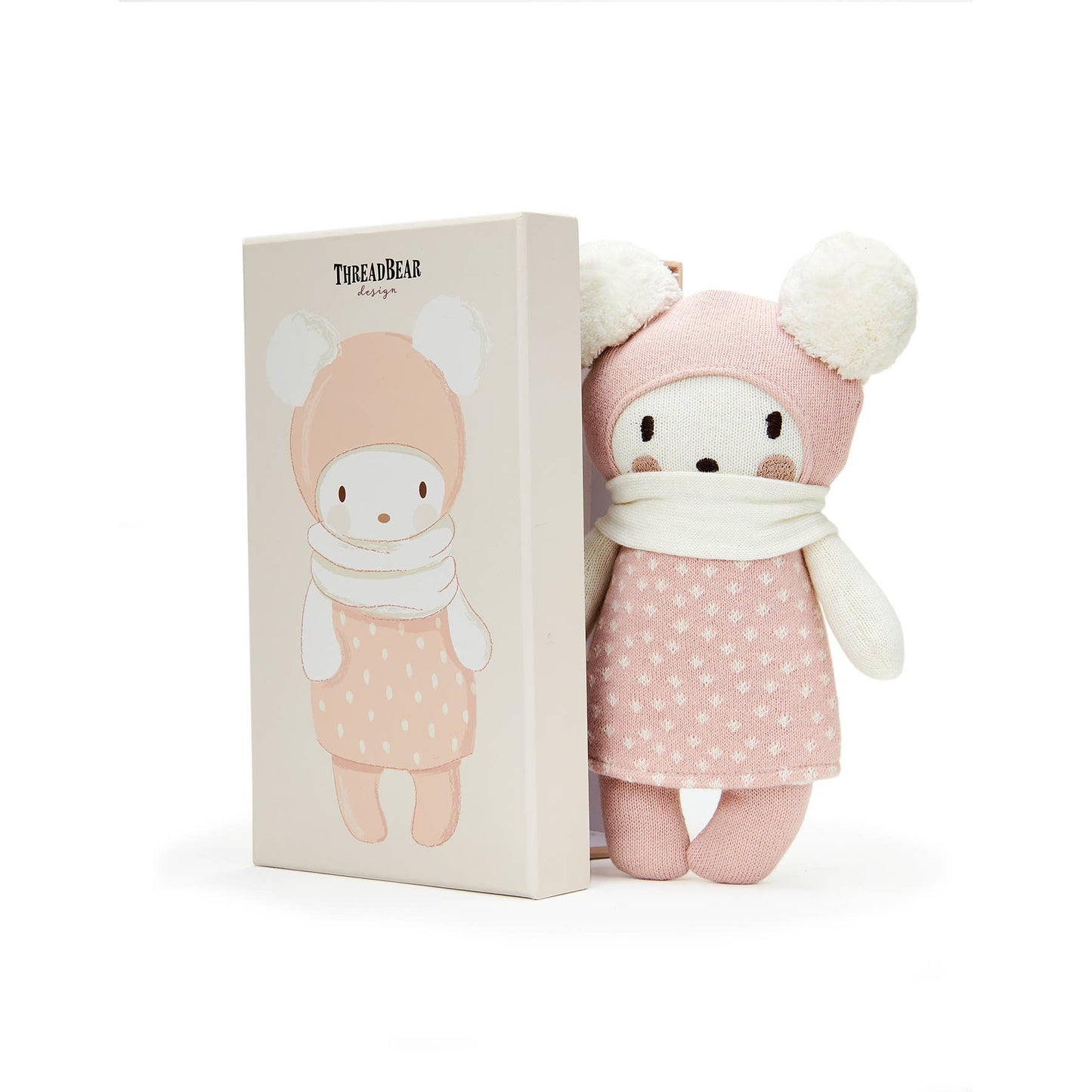 Stuffed toy in a pink outfit with matching packaging on a white background