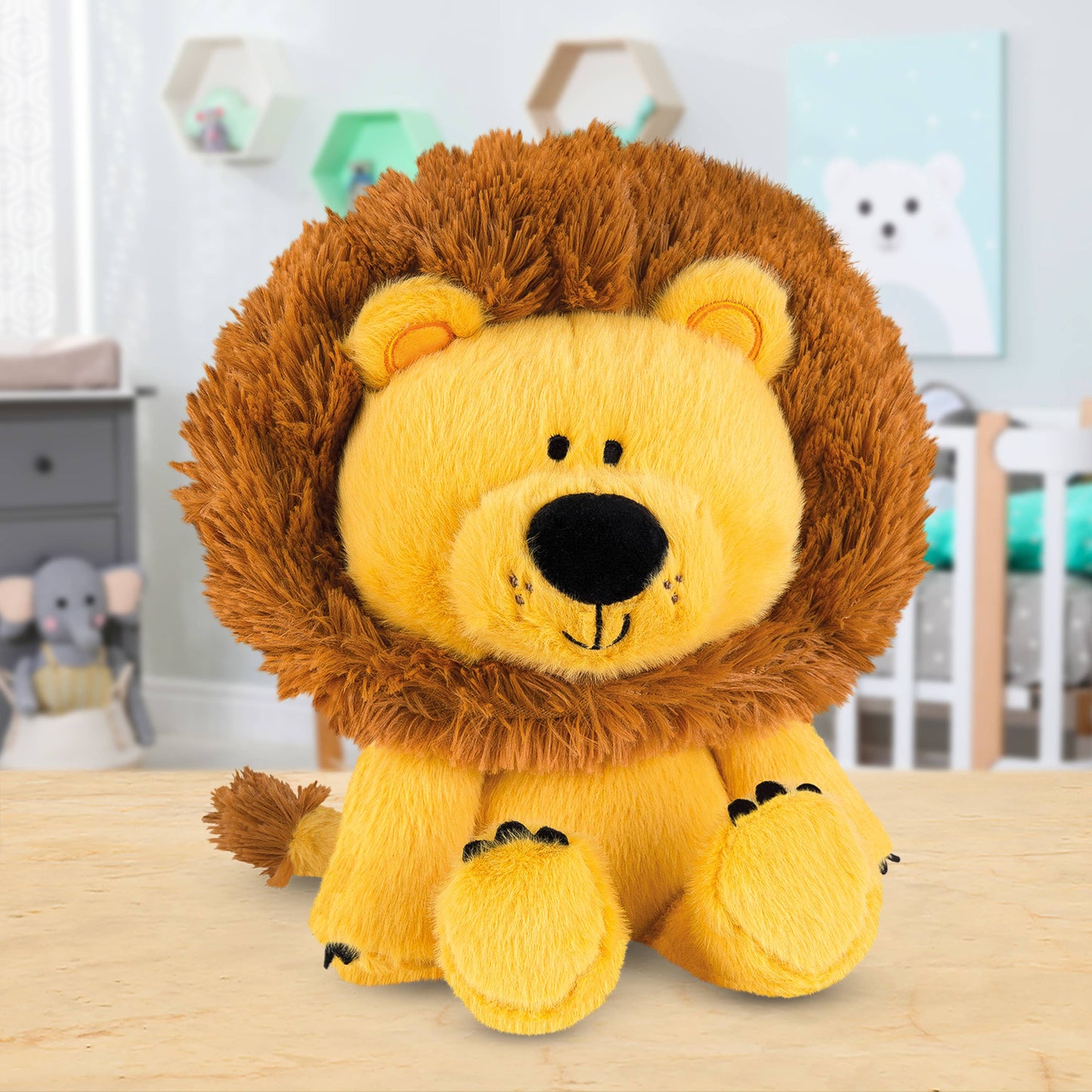 Plush lion toy on a wooden surface with a blurred nursery background
