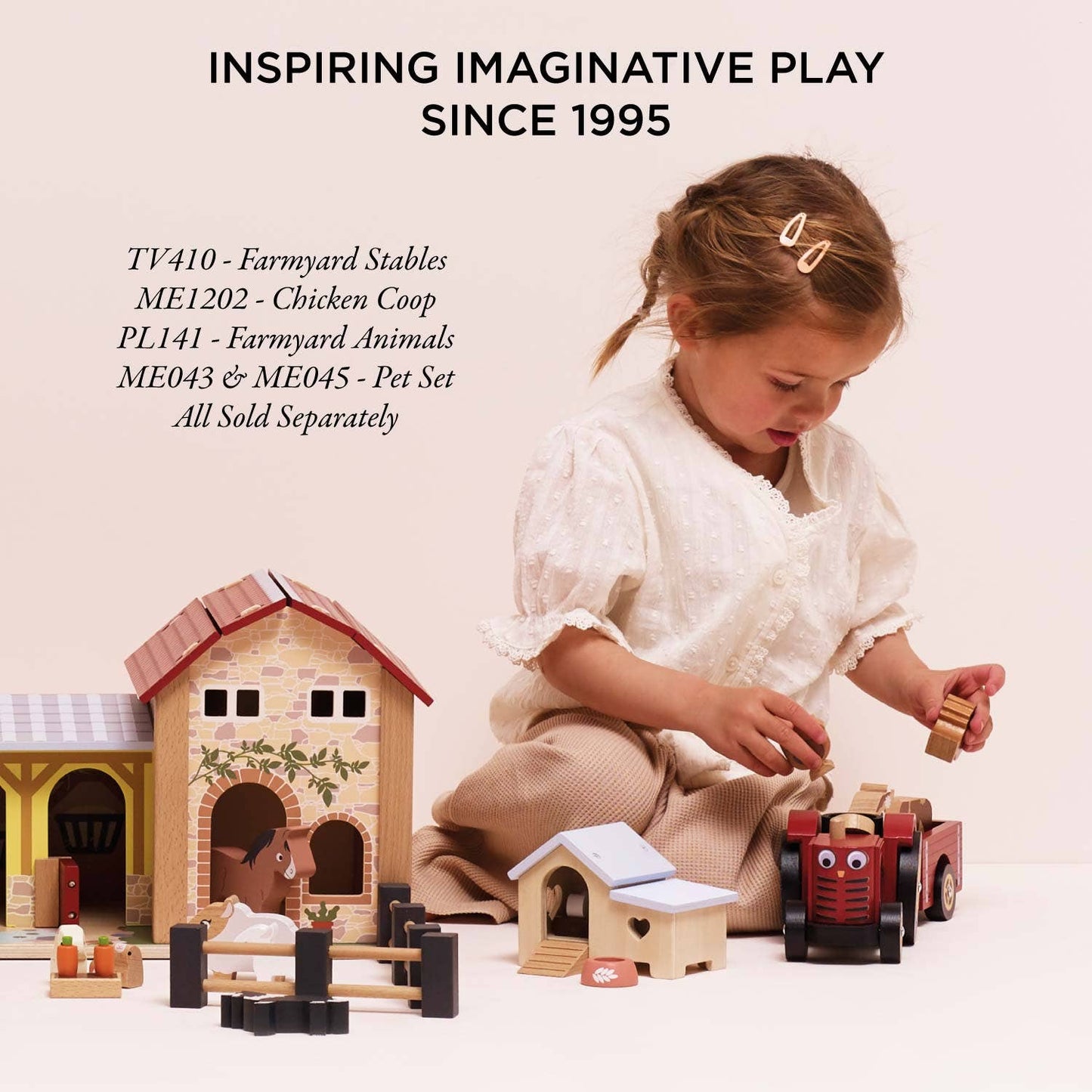 Child playing with toy farm set on a light background
