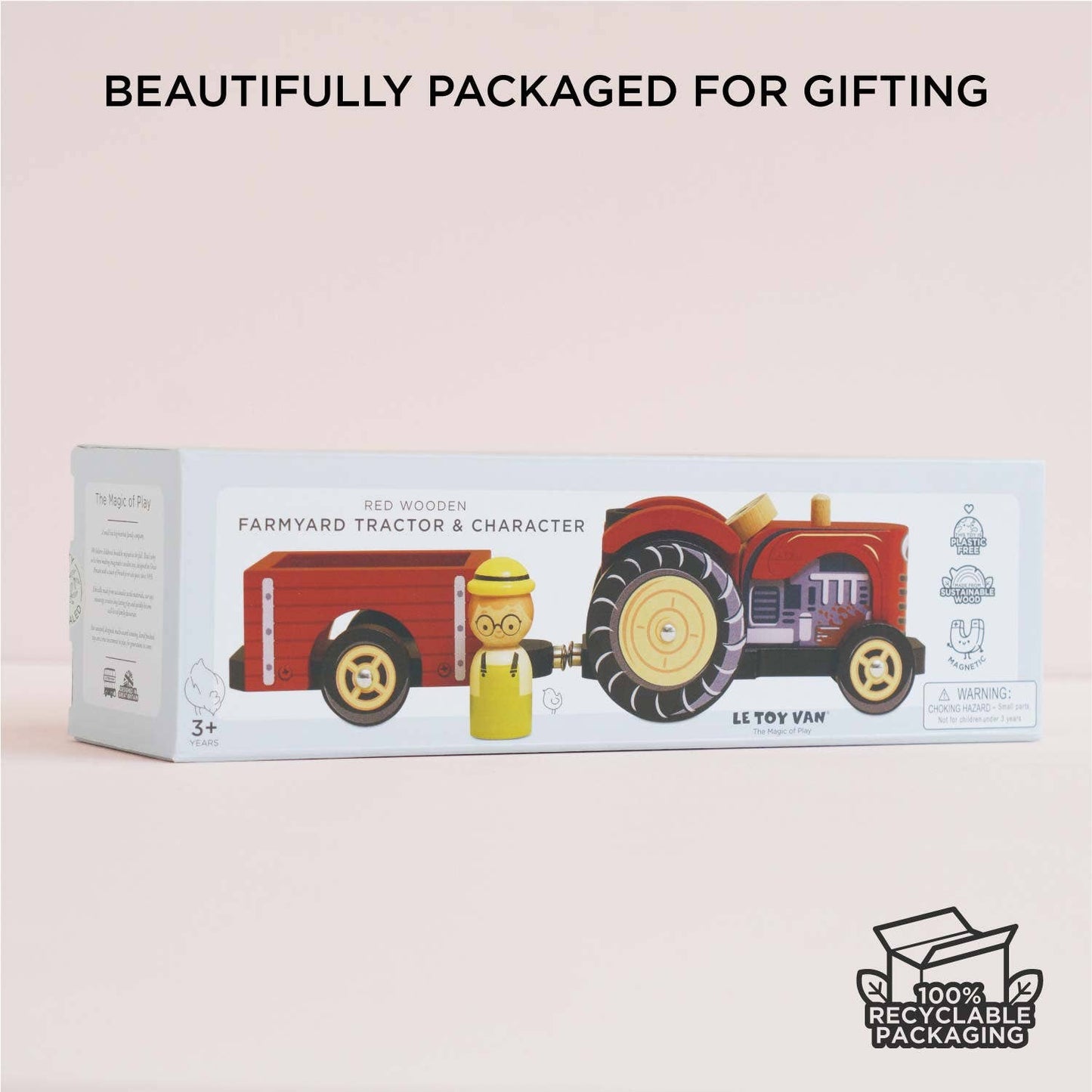 Toy tractor packaging with a child figure on a light pink background, featuring recyclable packaging logo.