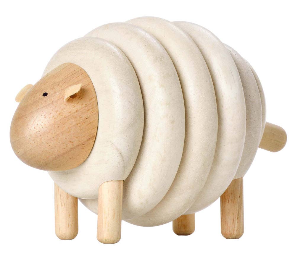 Wooden sheep toy on a white background