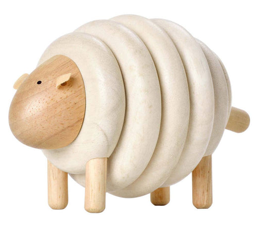 Wooden sheep toy on a white background