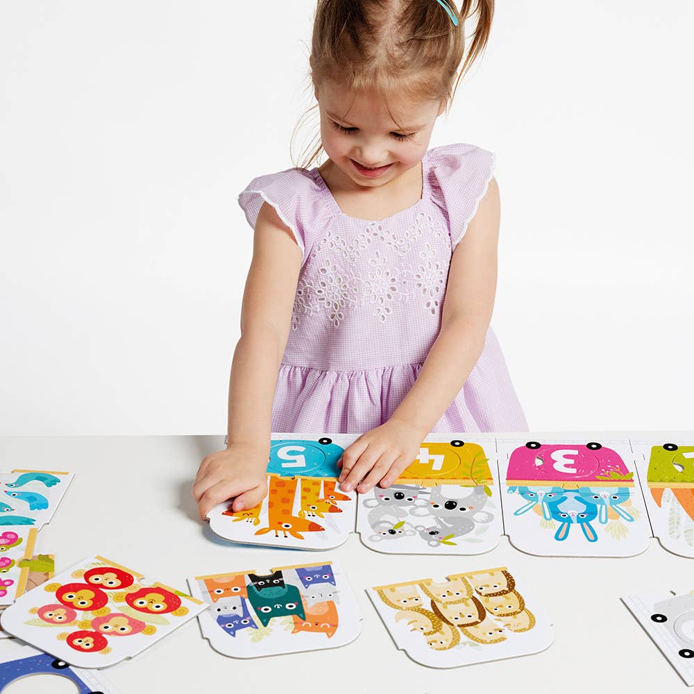 Child playing with educational card game featuring animals and numbers