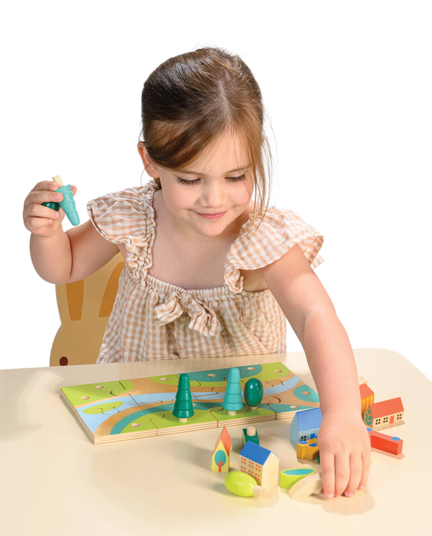 Child playing with a wooden puzzle on a table
