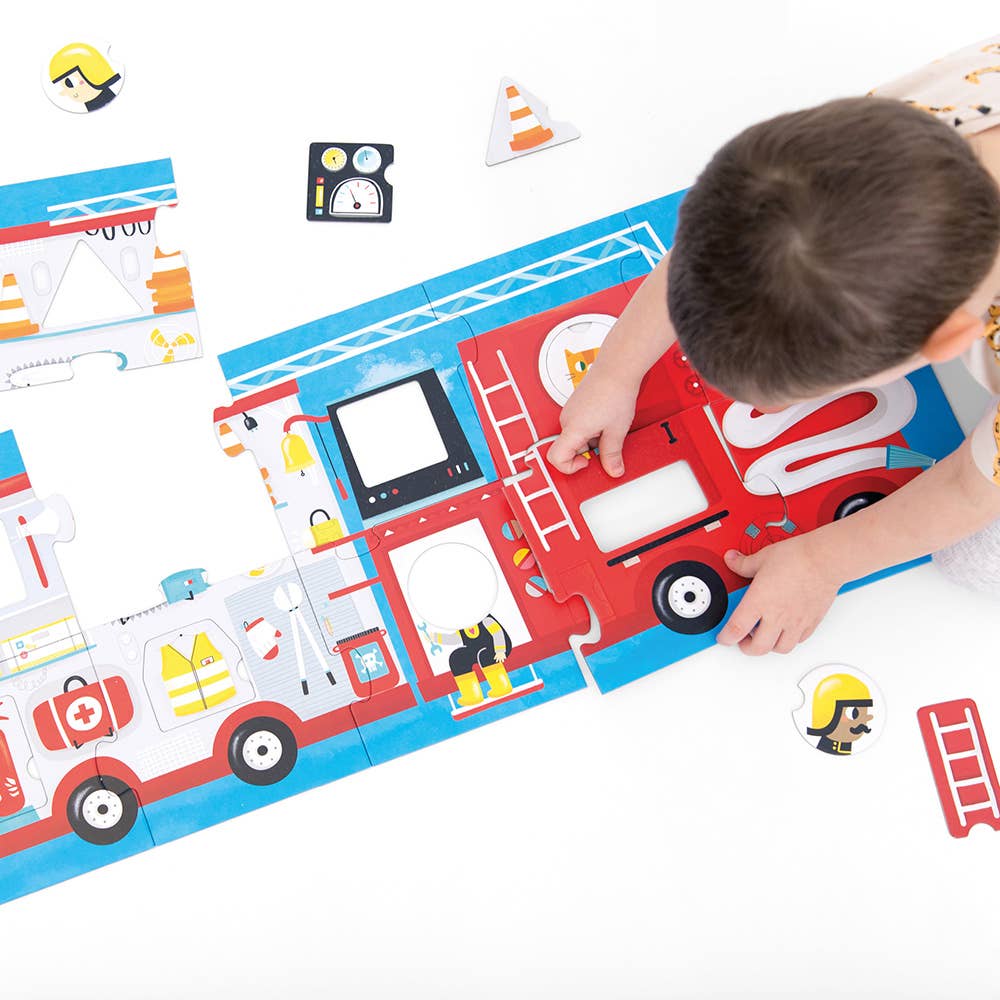 Child playing with a fire truck puzzle on a white surface