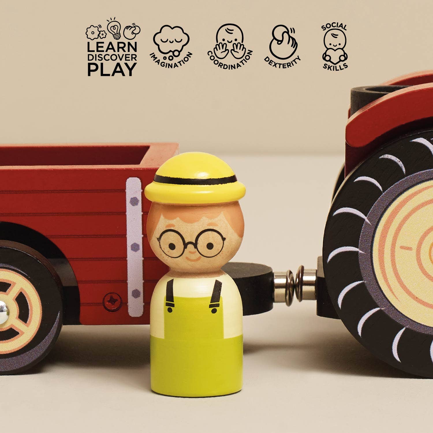 Toy figure with a red truck and character icons indicating skills like learning, discovery, and play.