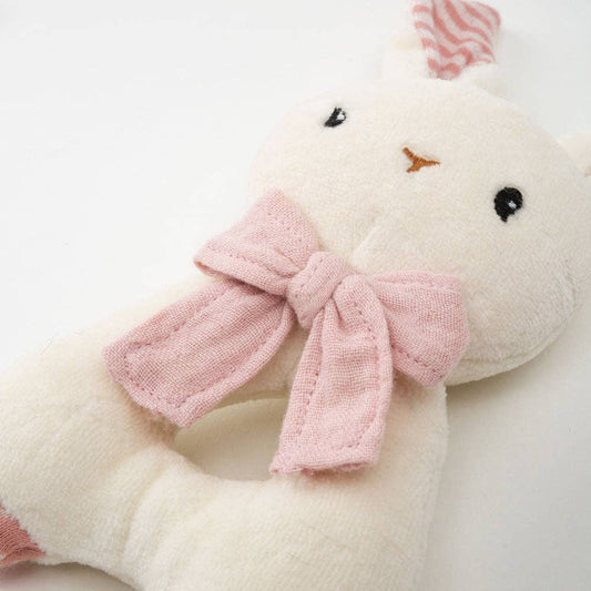 White plush toy with a pink bow on a light gray background