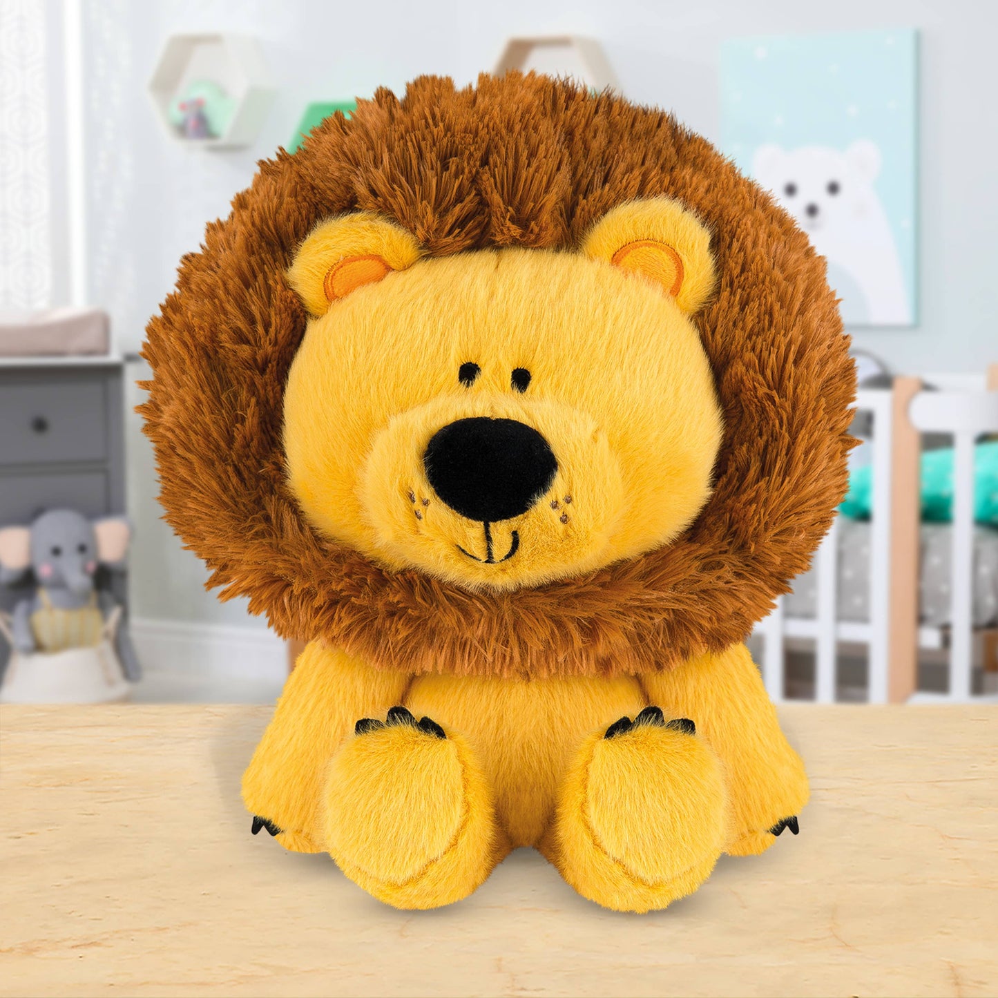 Plush lion toy on a wooden surface with a blurred background