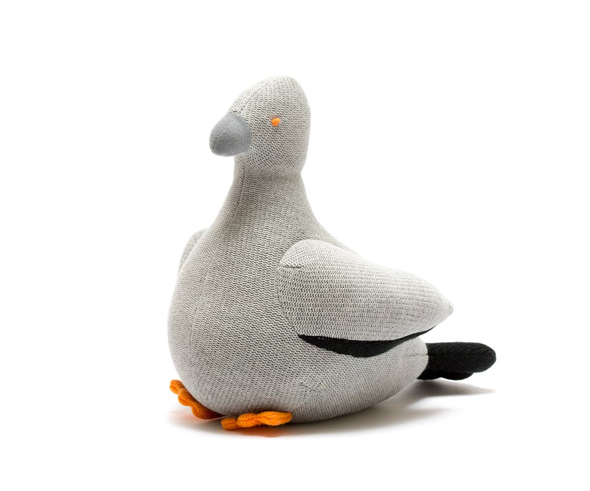 Gray plush pigeon toy with orange feet on a white background