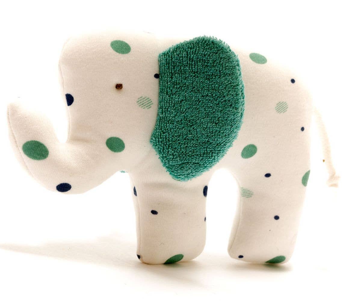 Stuffed elephant toy with green polka dots on a white background