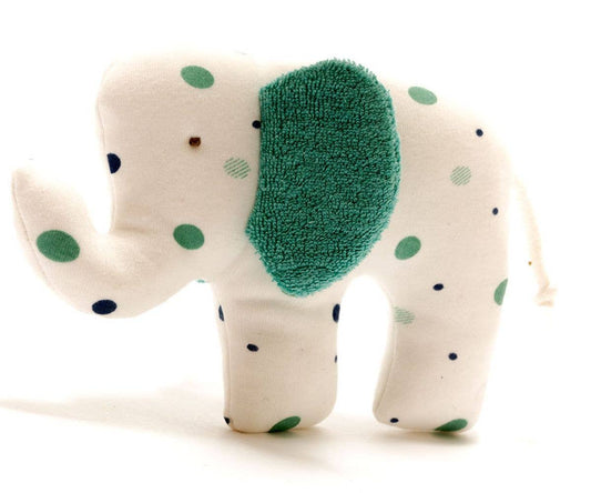 Stuffed elephant toy with green polka dots on a white background