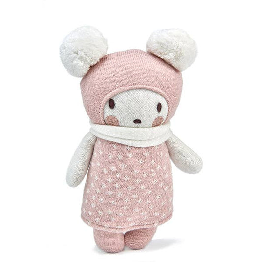 Stuffed toy with pink outfit and white pom-poms on a white background