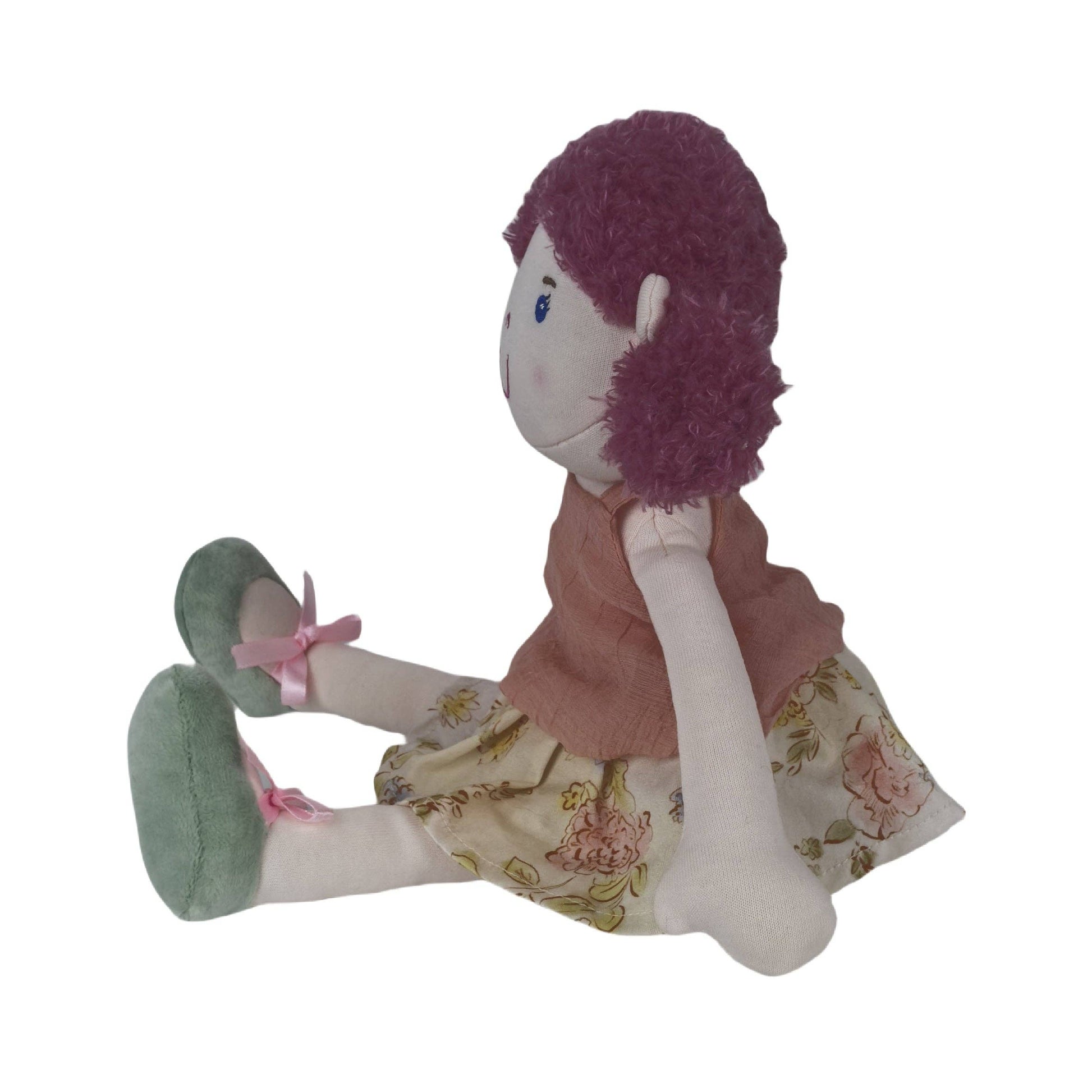 Plush toy doll with purple hair and floral dress on a white background