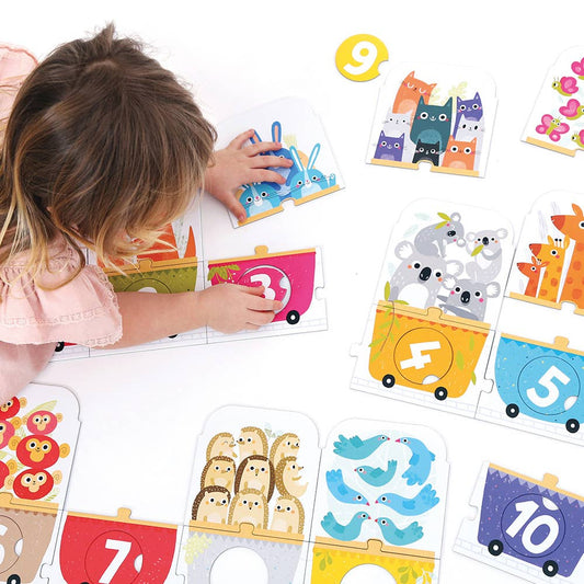Child playing with educational number cards featuring animals and numbers.