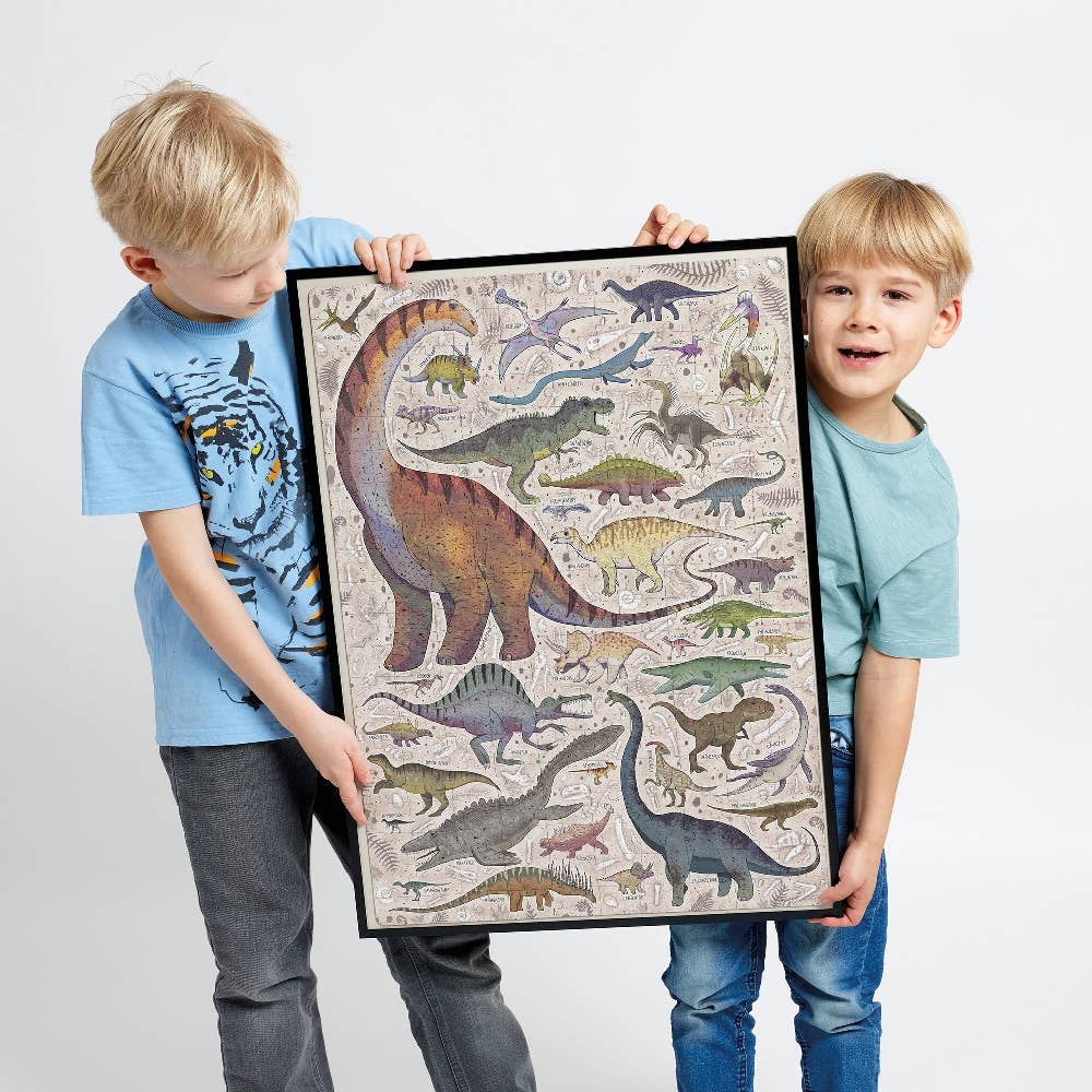 Two children holding a framed dinosaur illustration against a plain background