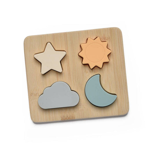 Wooden puzzle with star, sun, cloud, and moon shapes on a wooden board.