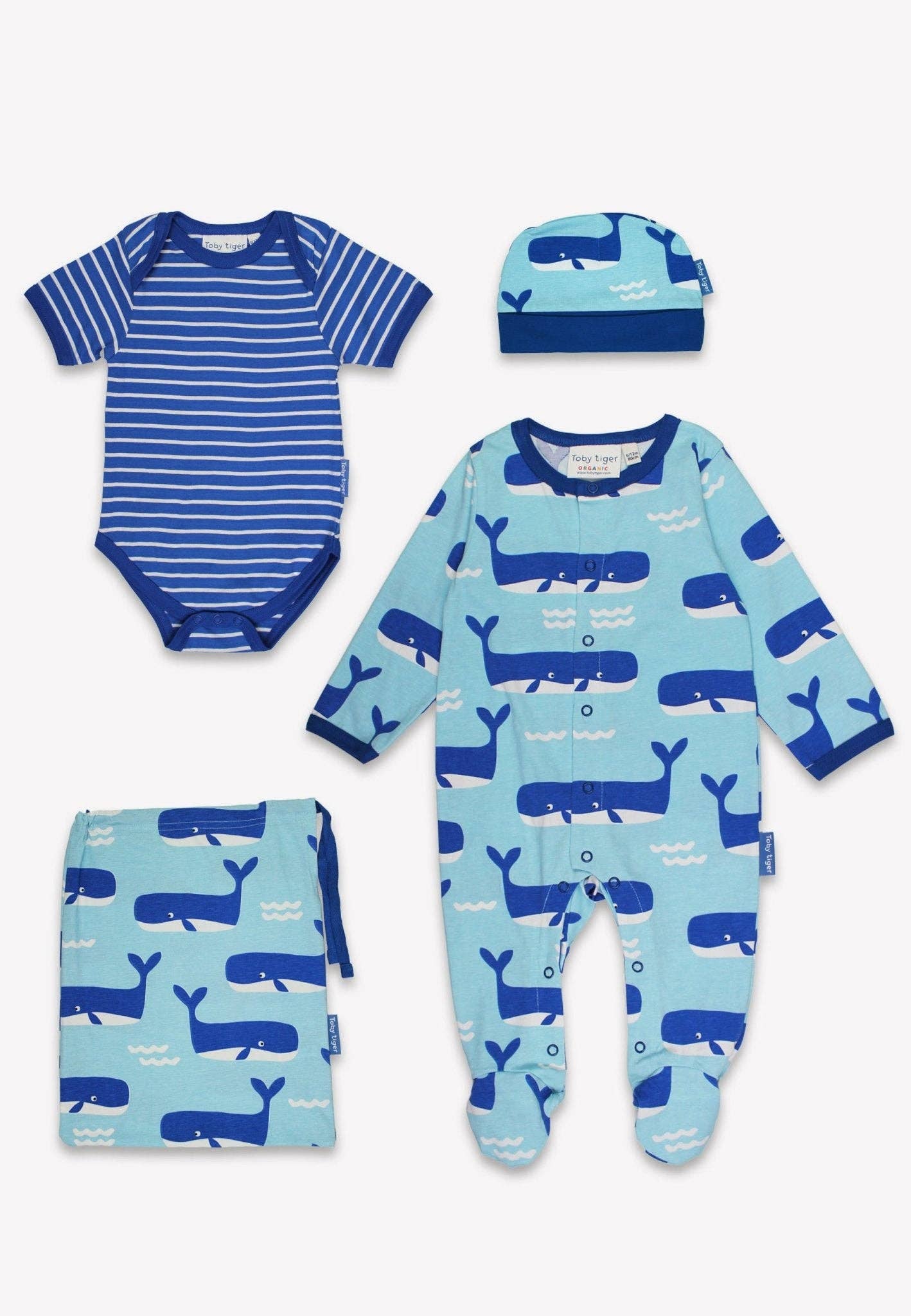 Baby clothing set with blue whale patterns on a white background