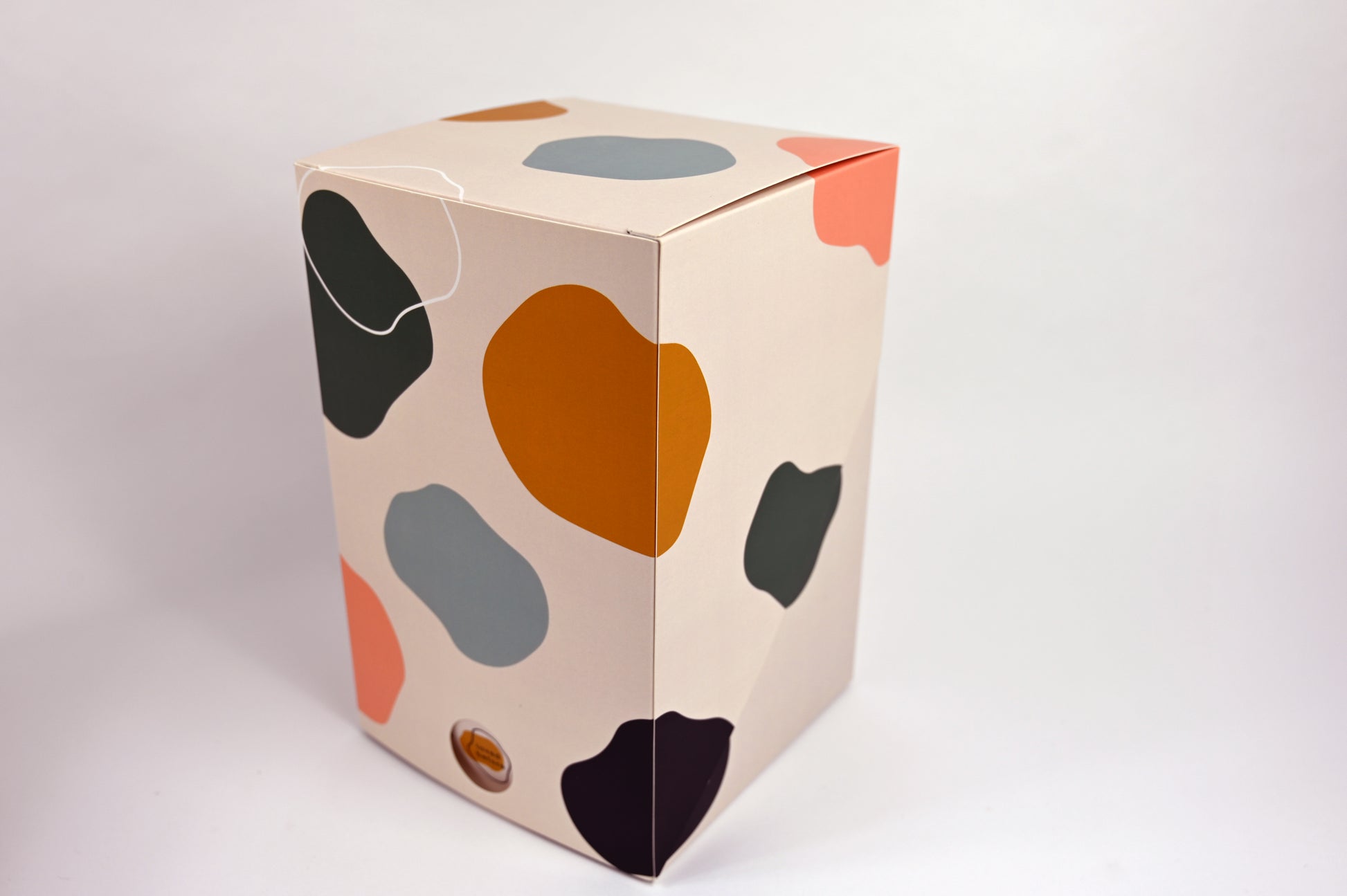Cardboard box with colorful abstract patterns on a white background