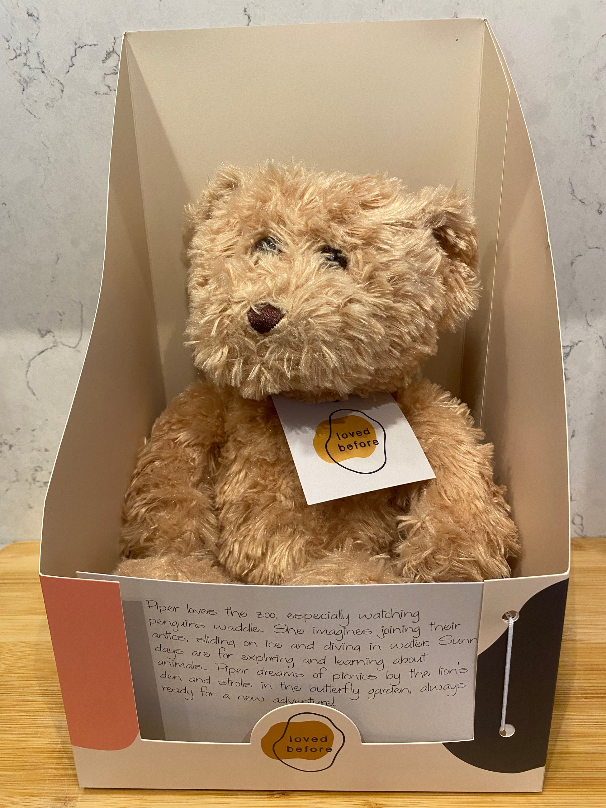 Teddy bear in a Loved Before box with a story card 