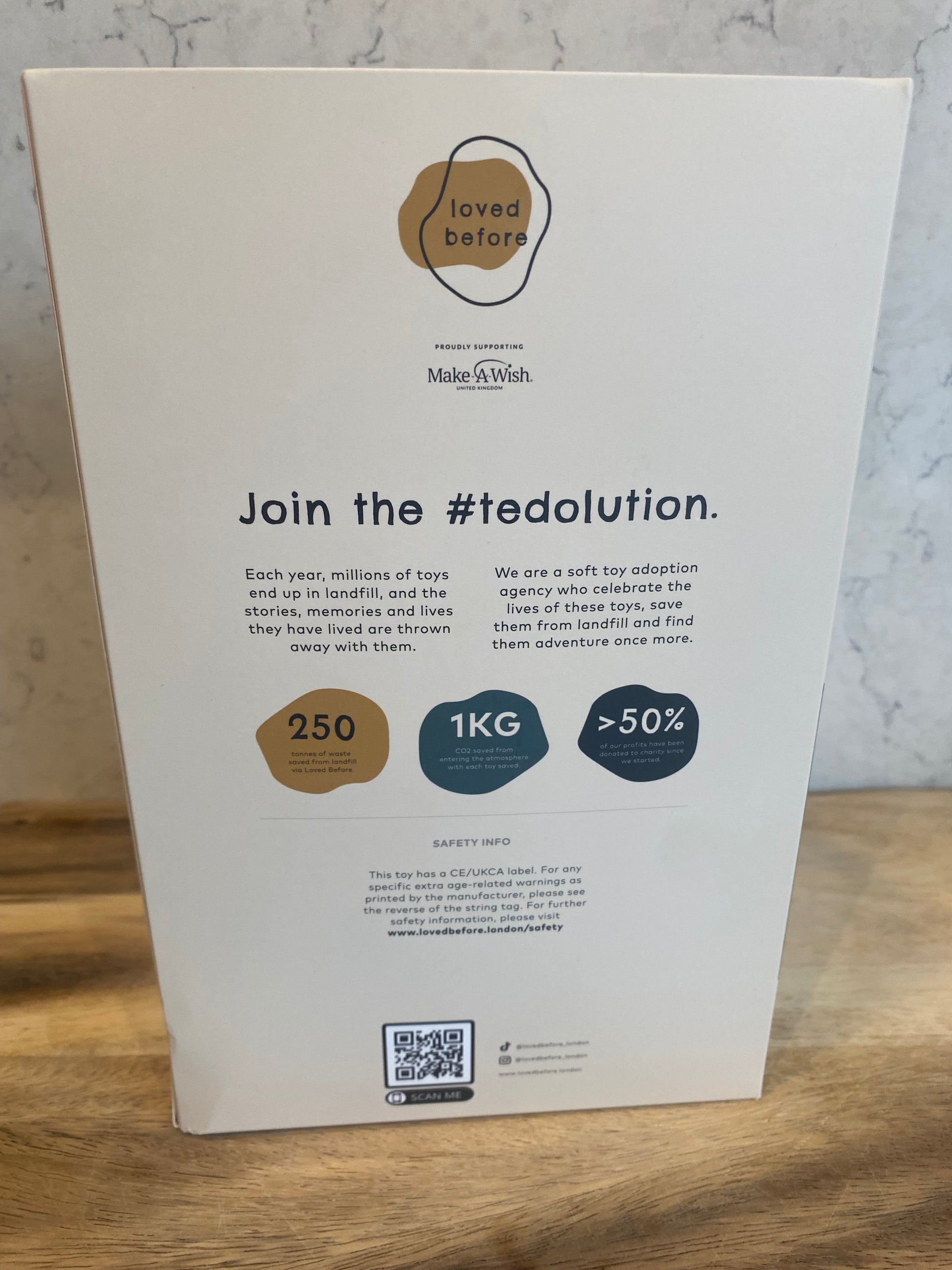 Product packaging with text and icons on a wooden surface