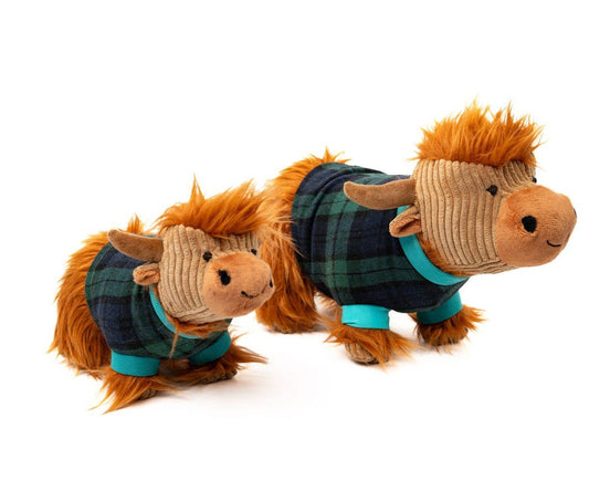 Two plush Highland cow toys wearing plaid sweaters on a white background