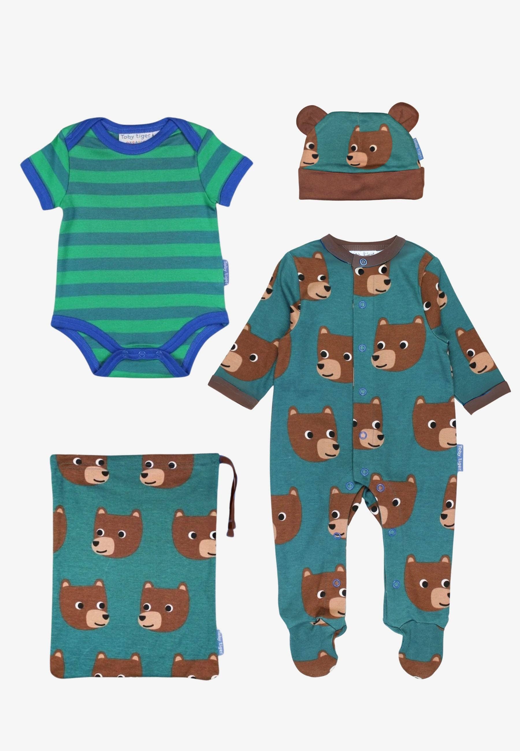 Set of baby clothing including a onesie, bodysuit, and hat with bear pattern on a white background.