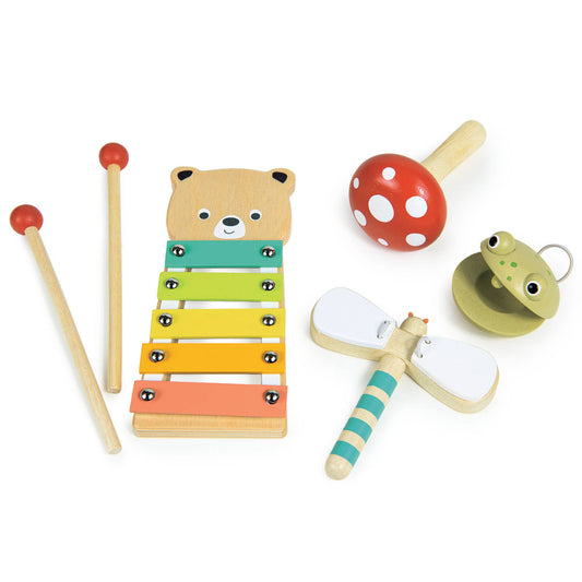 Set of colorful wooden toys including a xylophone, mallets, and other instruments on a white background
