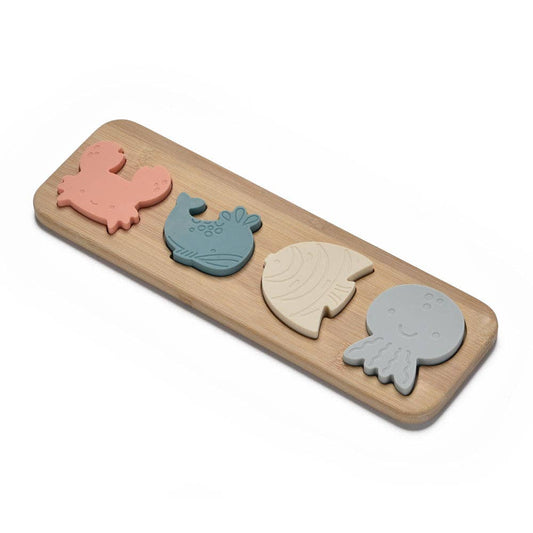 Set of four silicone animal-shaped molds on a wooden board with a white background
