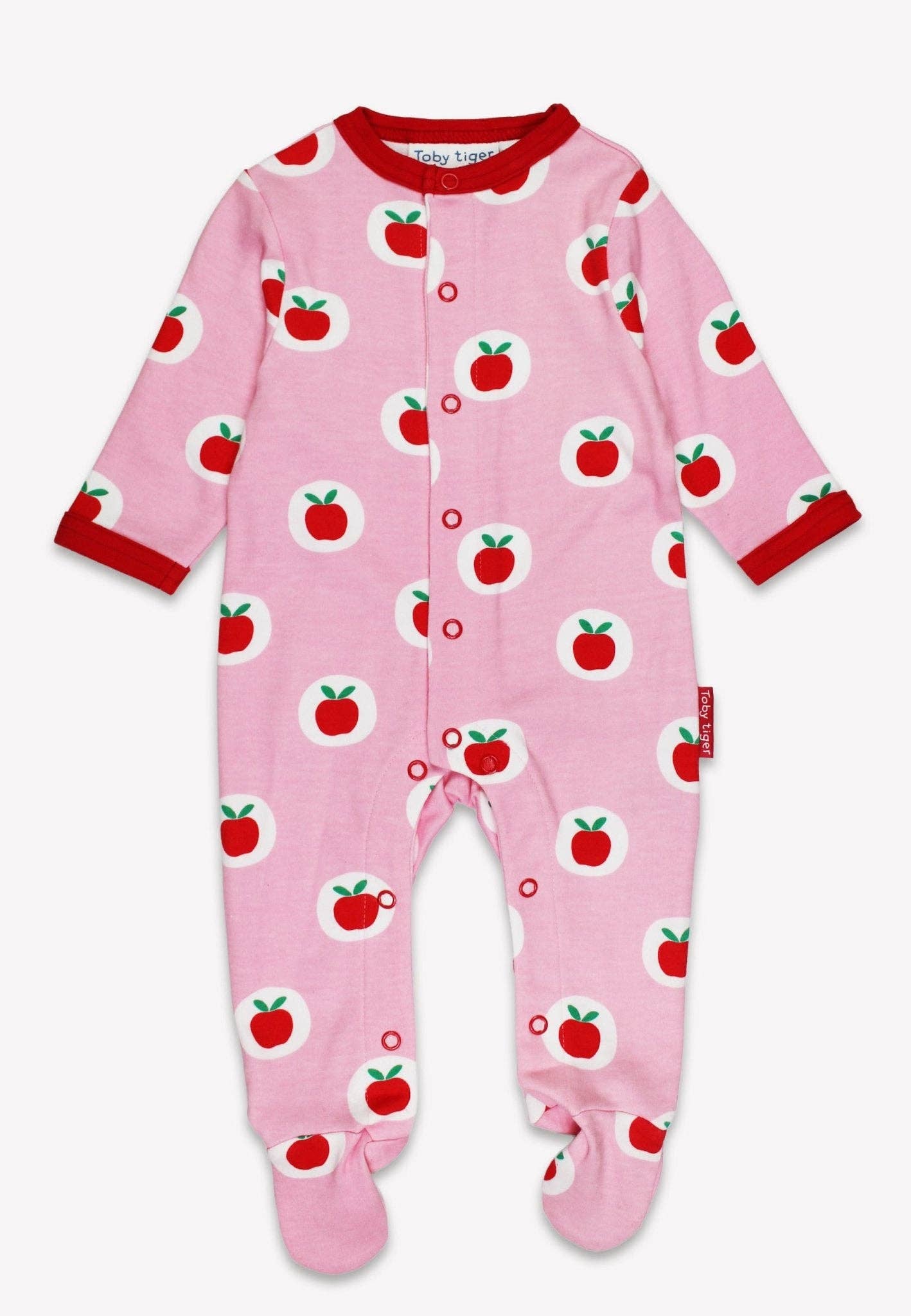 Pink baby onesie with apple pattern on a white background