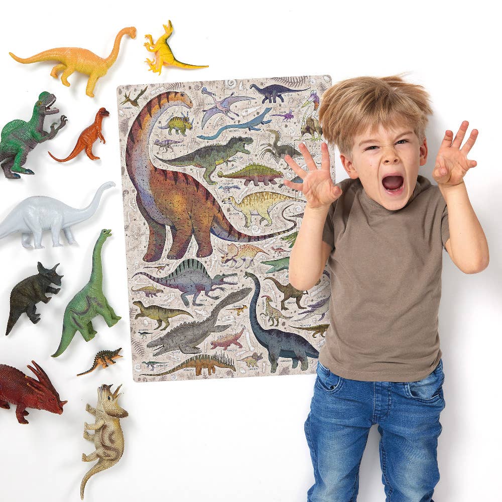 Child with dinosaur toys and a puzzle featuring dinosaurs on a white background
