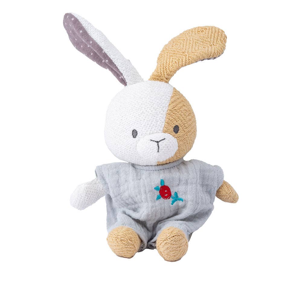 Plush toy rabbit in a gray outfit with a red heart on a white background