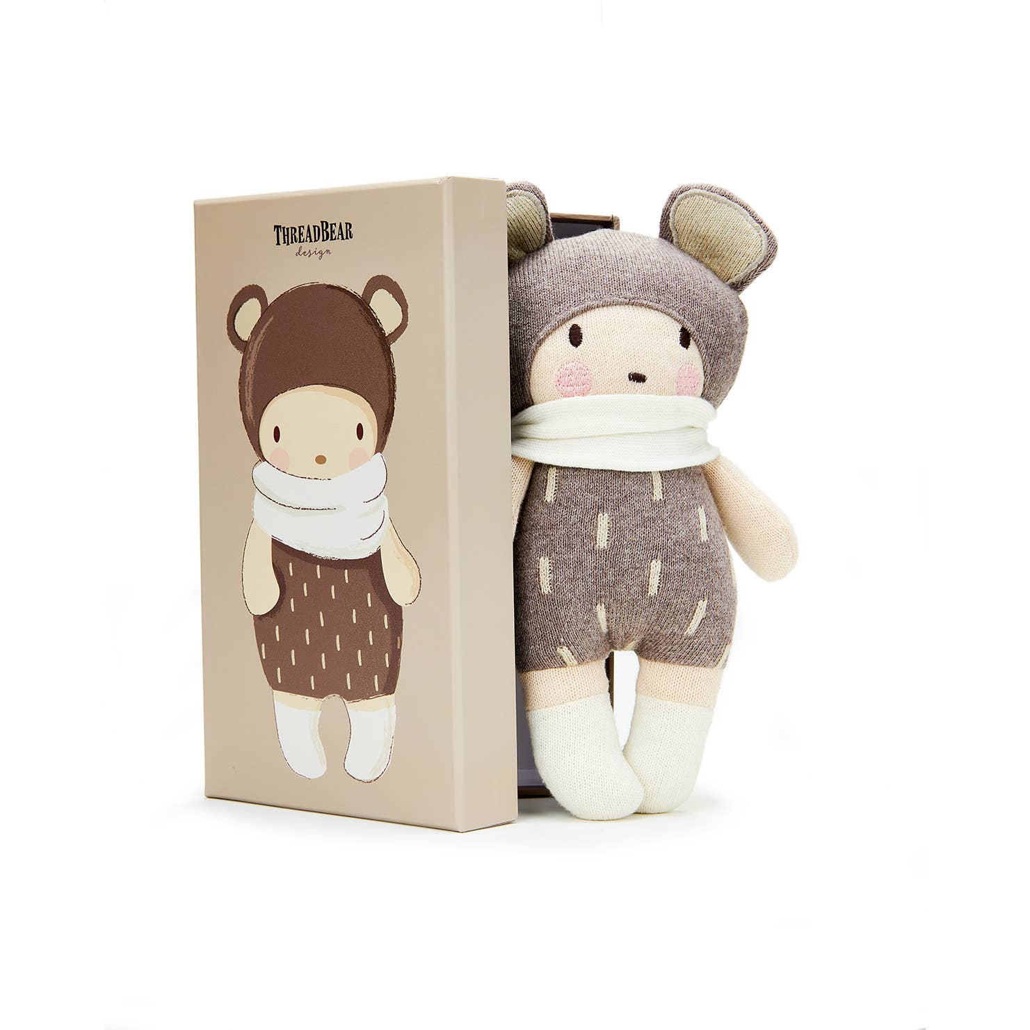 Stuffed toy with animal-themed outfit next to its packaging on a white background